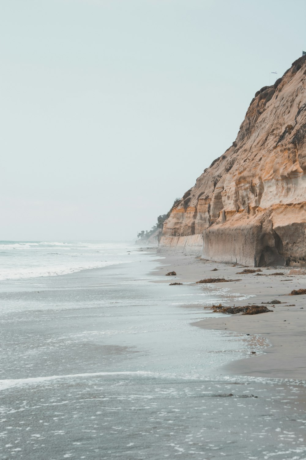 cliff near body of water during daytme