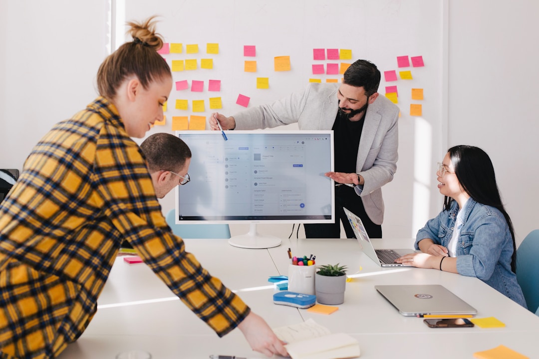 A team leader at a computer discussing contact center solutions.