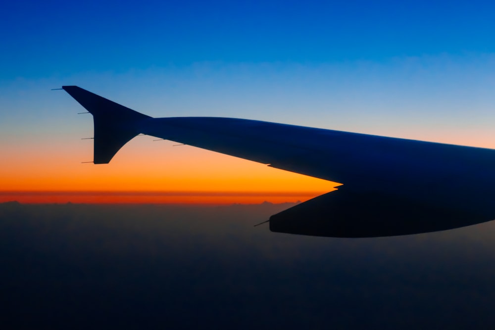 silhouette of plane during golden hour