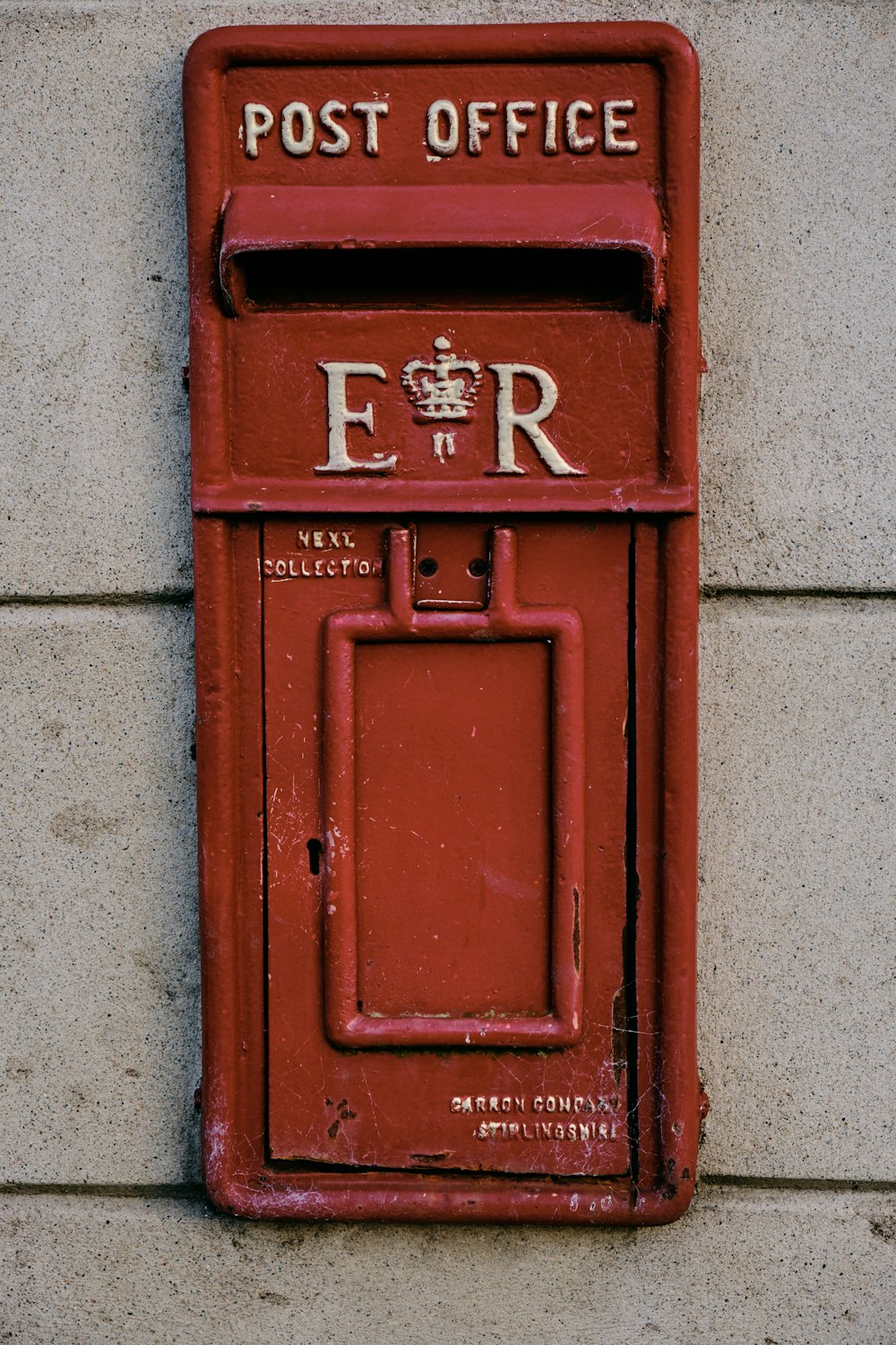 orange post-office mail box on wall