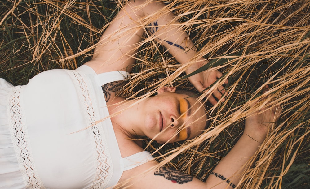 woman lying on brown grass