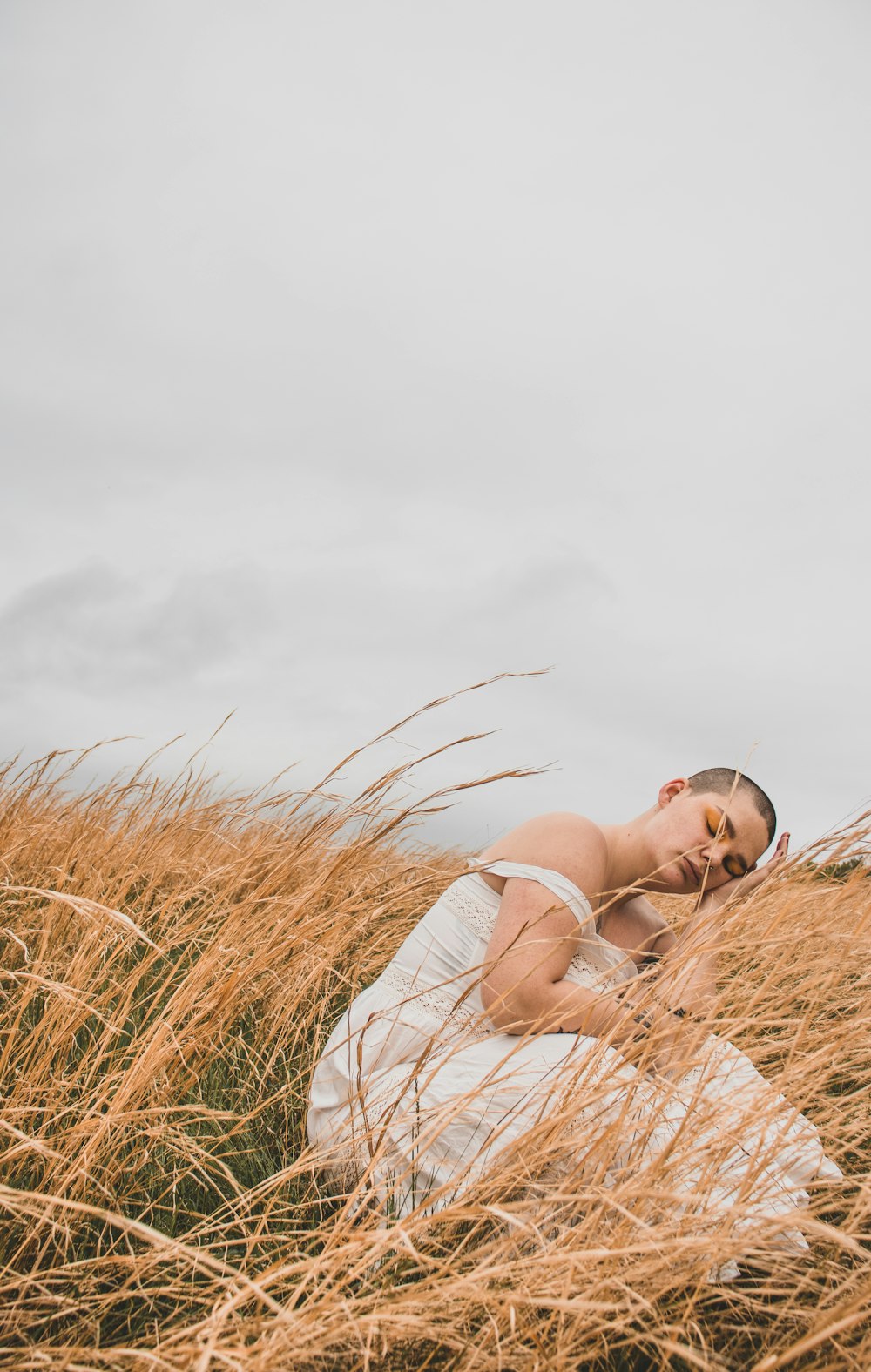 woman sitting on wheat grass