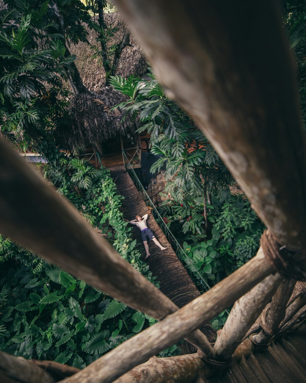 man lying on bridge