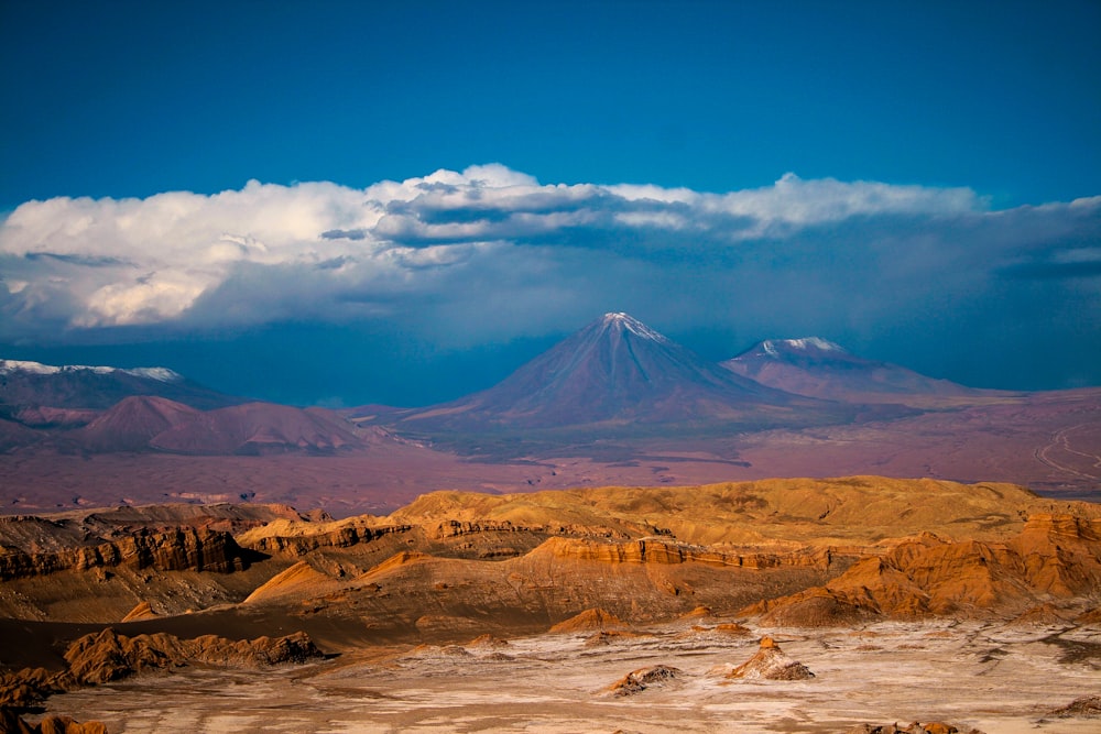 brown mountains under white clouds