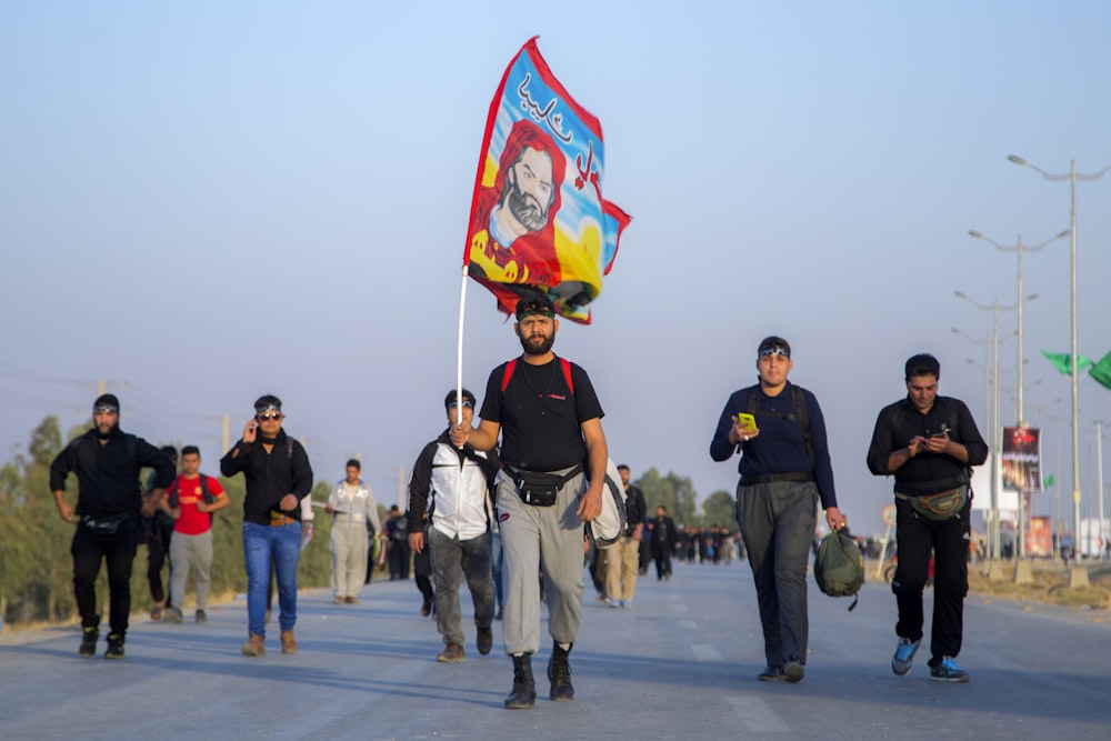 man in black T-shirt holding banner