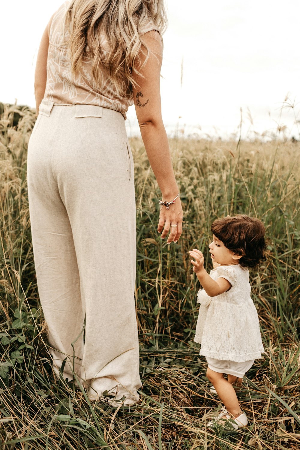 woman standing beside girl during daytime