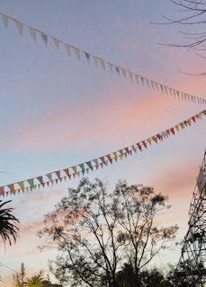 Sunset over a community garden decorated with British bunting and Moroccan lanterns, creating a warm atmosphere