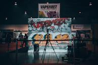 Behind-the-scenes of a music video shoot with urban graffiti walls and dynamic lighting.