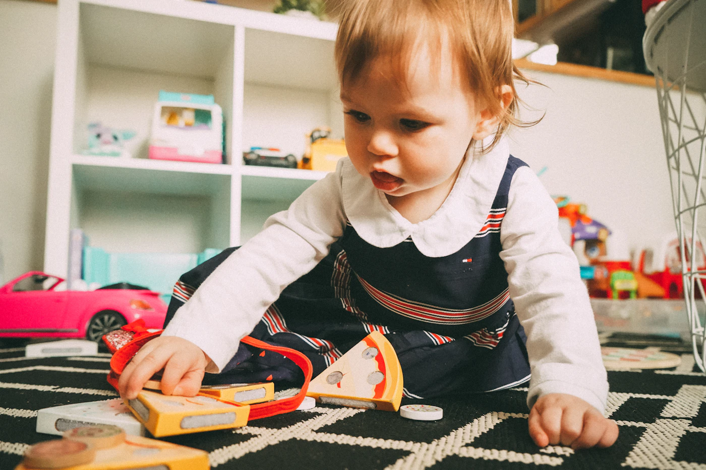 A caring professional playing with a happy toddler