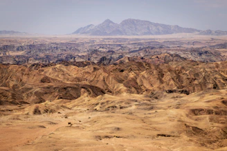 Expansive Saharan desert landscape under a bright blue sky.