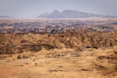 Expansive Saharan desert landscape under a bright blue sky.