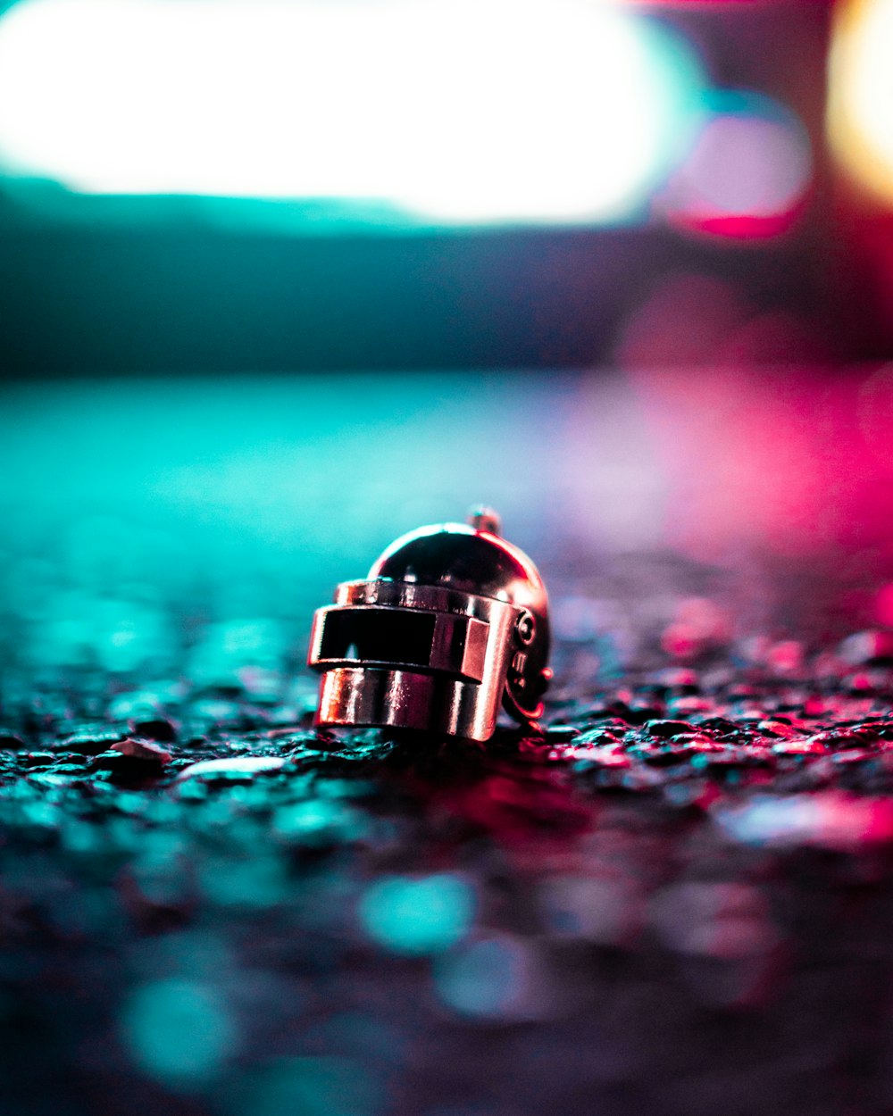 grey helmet keychain selective focus photography