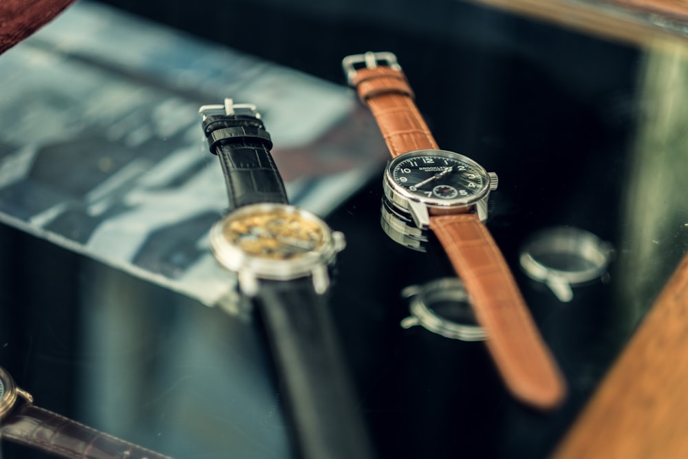 shallow focus photo of two round silver-colored watches