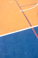 a man standing on top of a basketball court holding a racquet