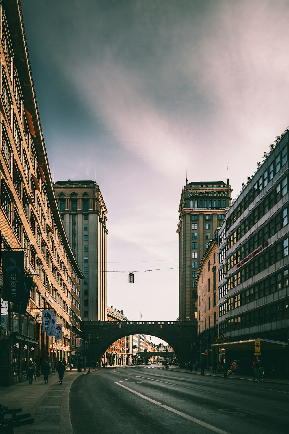 bridge, road, and buildings during day