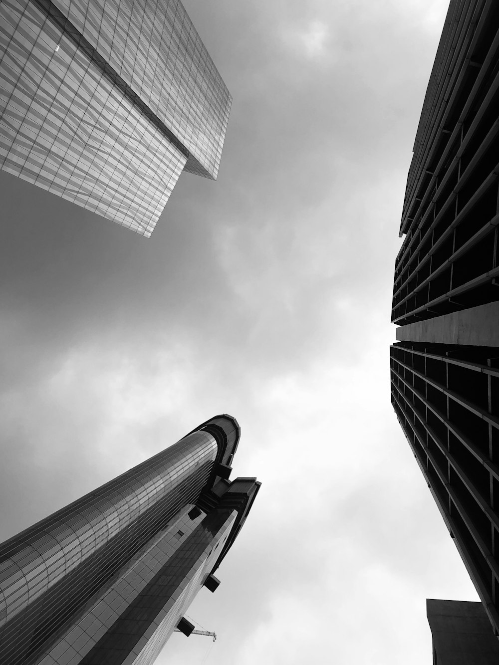 low-angle photography of three high-rise buildings