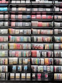 A bookshelf filled with various colorful novels.