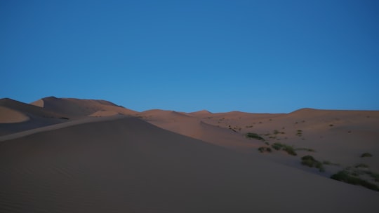 aerial photography of desert under clear blue sky in Alxa Zuoqi China