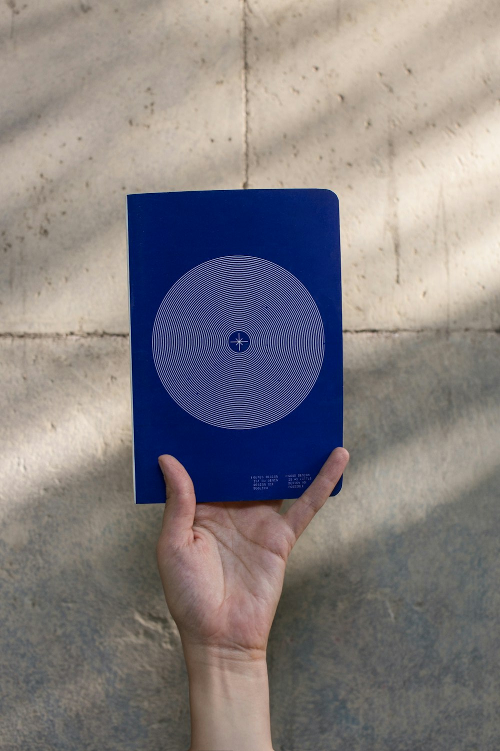 person holding rectangular blue plastic case