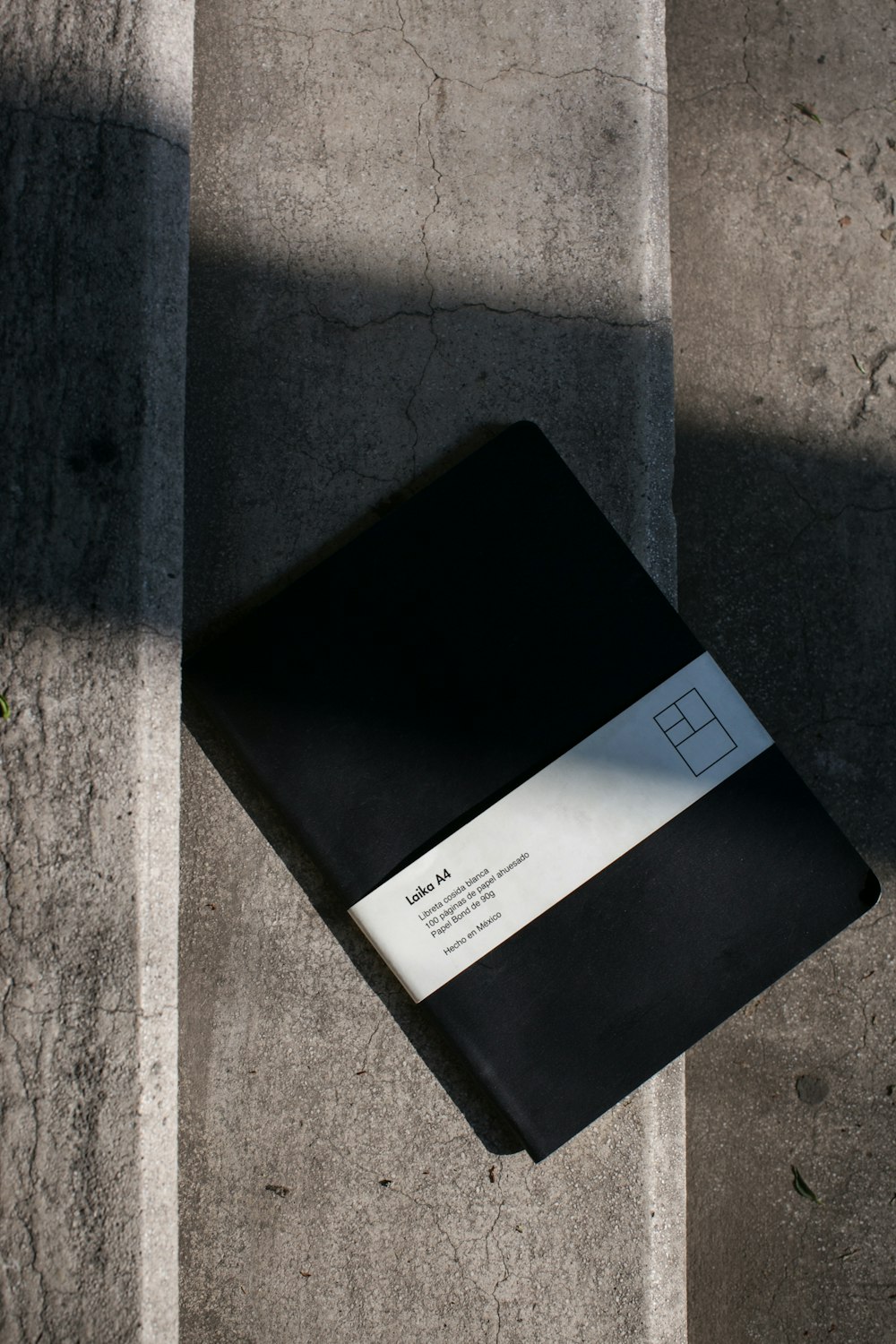 black labeled book on grey concrete staircase