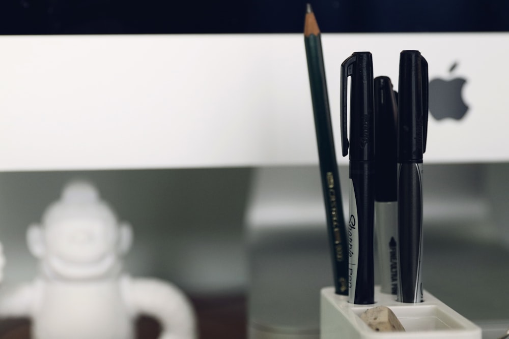 pen and pencil in organizer close-up photography
