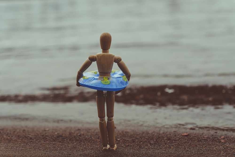 brown wooden toy on seashore