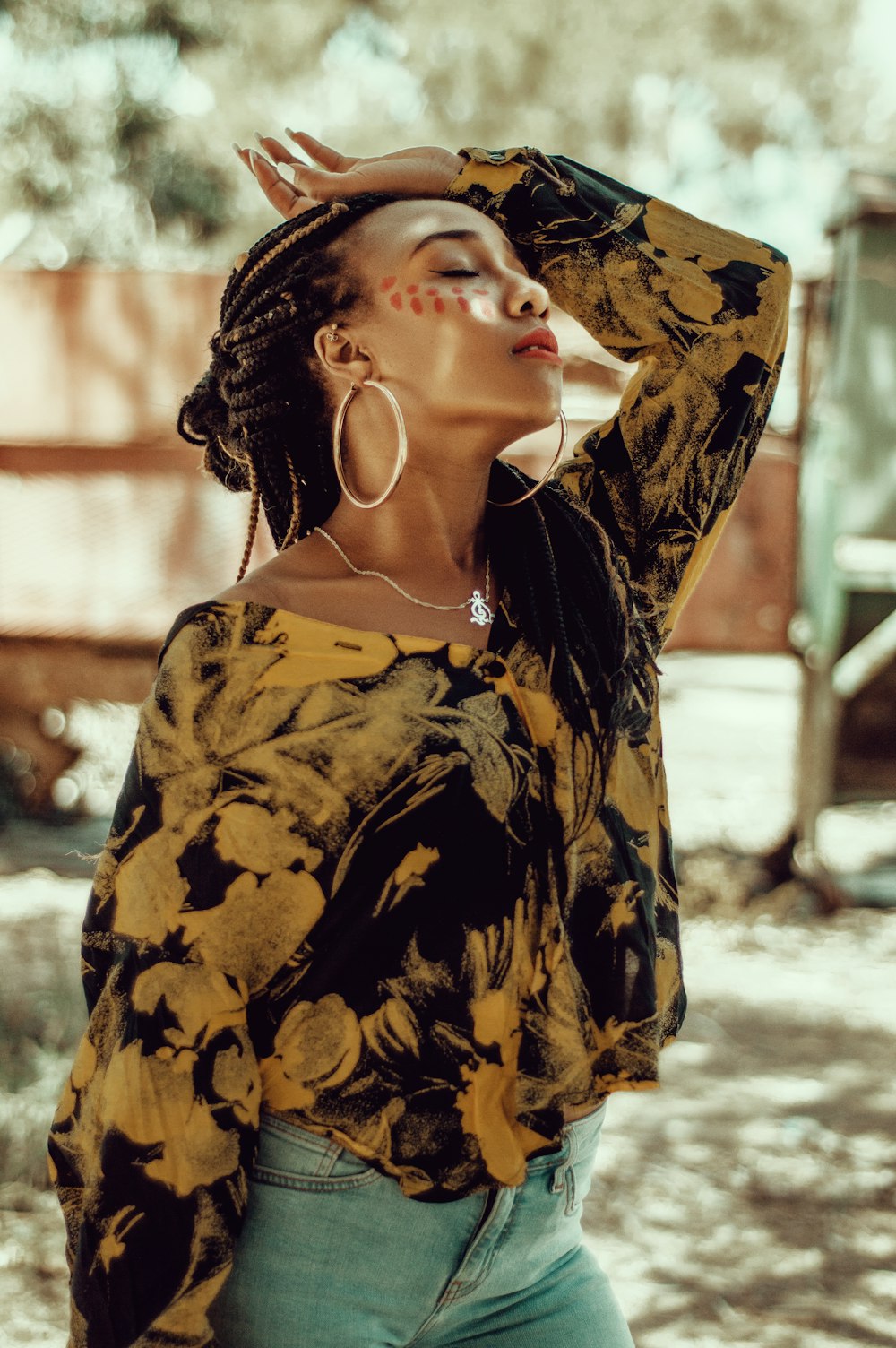 woman in brown and black floral top