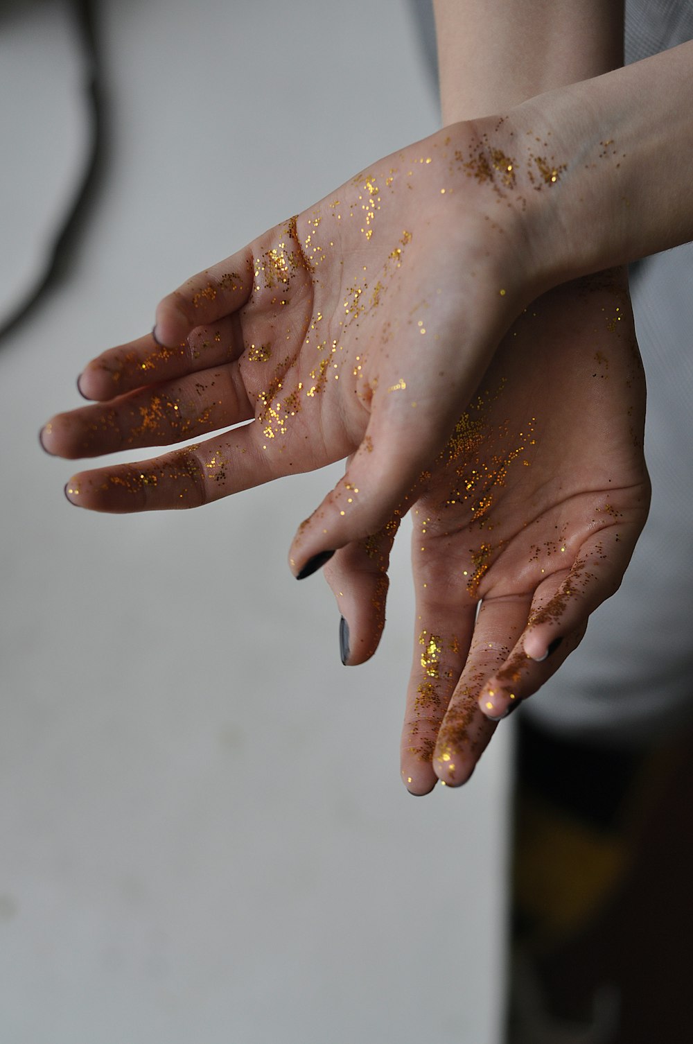 person's hand with glitters