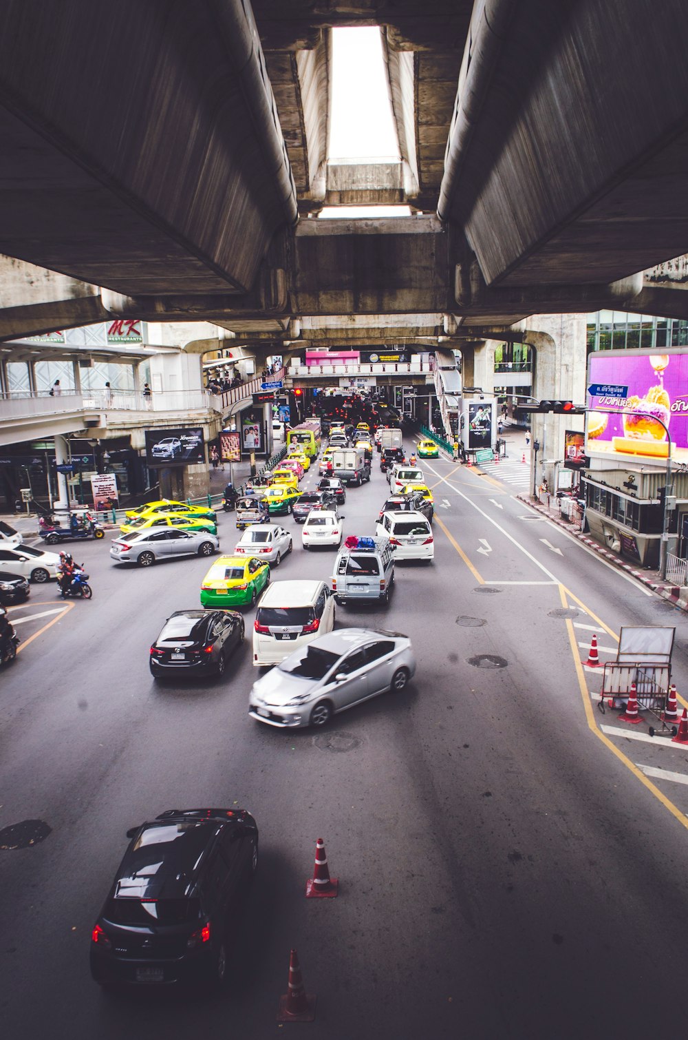 vehicles on road under bridge