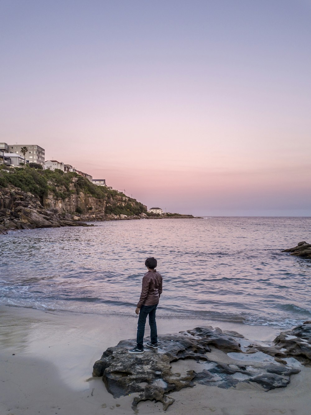 man standing on the seashore