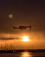 Drone capturing aerial view of a winding canal survey at sunrise