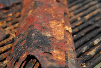 Engineer explaining corrosion effects on metal samples during a technical training session.