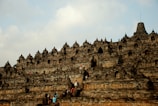 people walking on rock castle