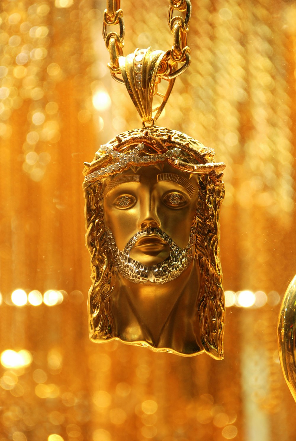 gold-colored Jesus Christ pendant