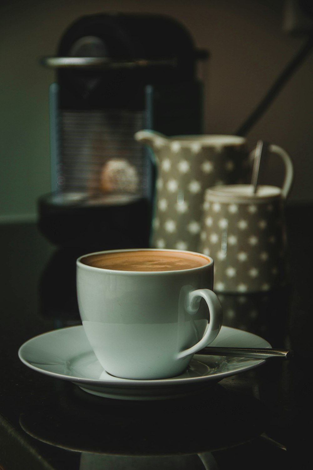 white cup on saucer