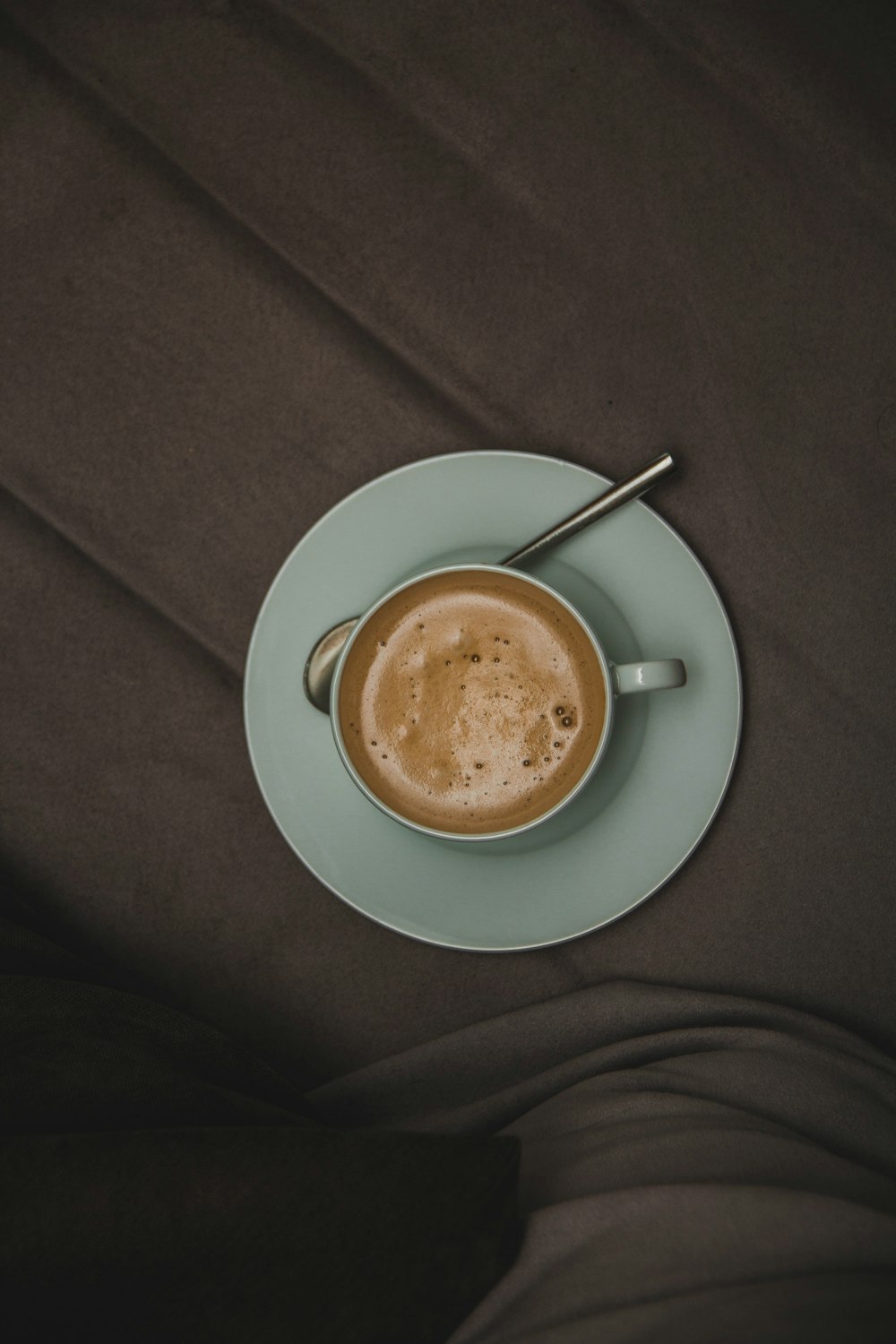 green cup on saucer