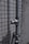 A metal pipe with a valve is mounted on a tiled wall. The wall has a pattern of small, square tiles. The surface appears weathered, suggesting exposure to outdoor elements.