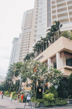 A friendly Maplewise team member warmly greeting a newcomer family outside a modern apartment building.