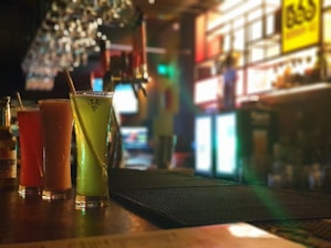 A vibrant bar counter displaying colorful mocktails in various glassware.