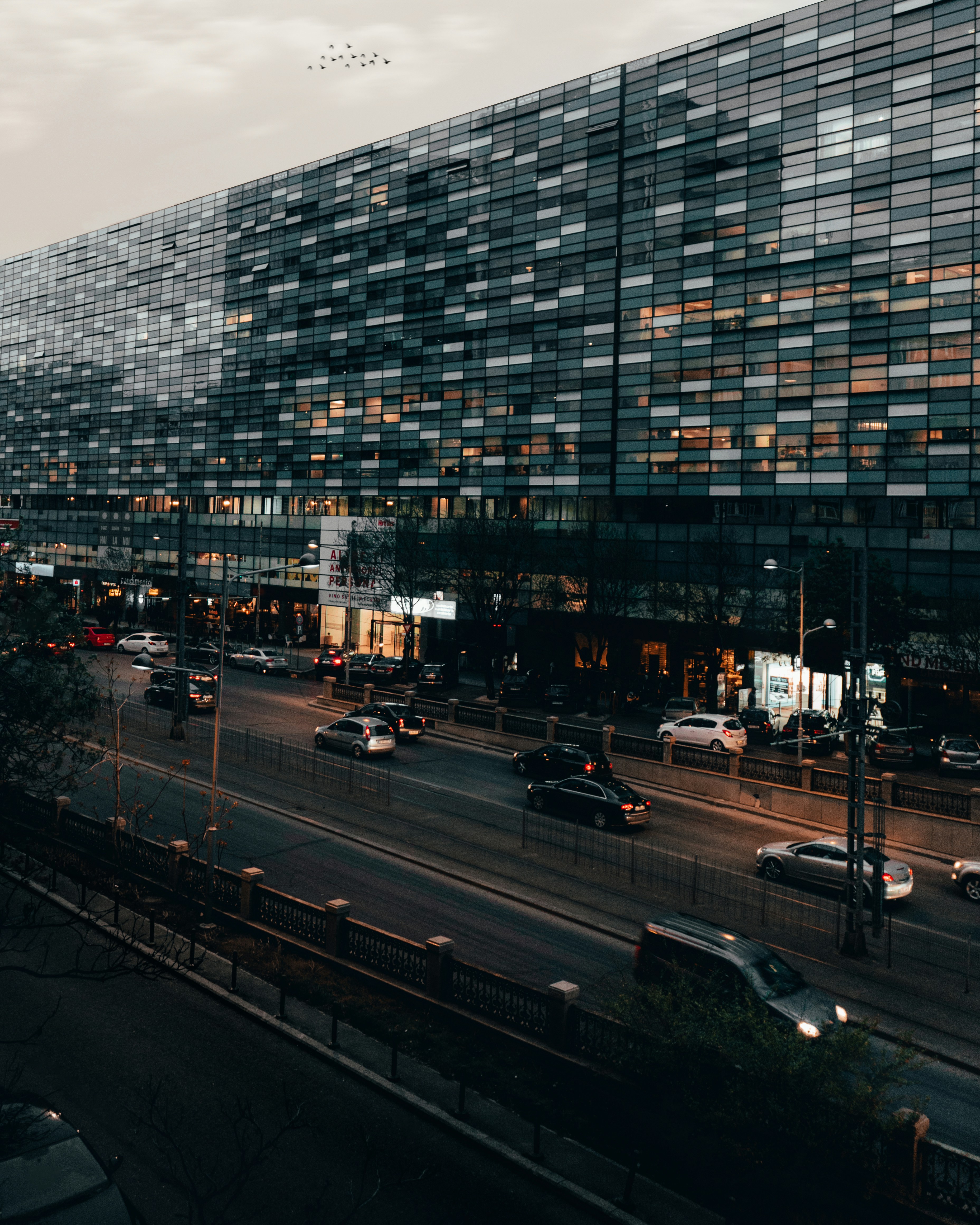 vehicles passing by building