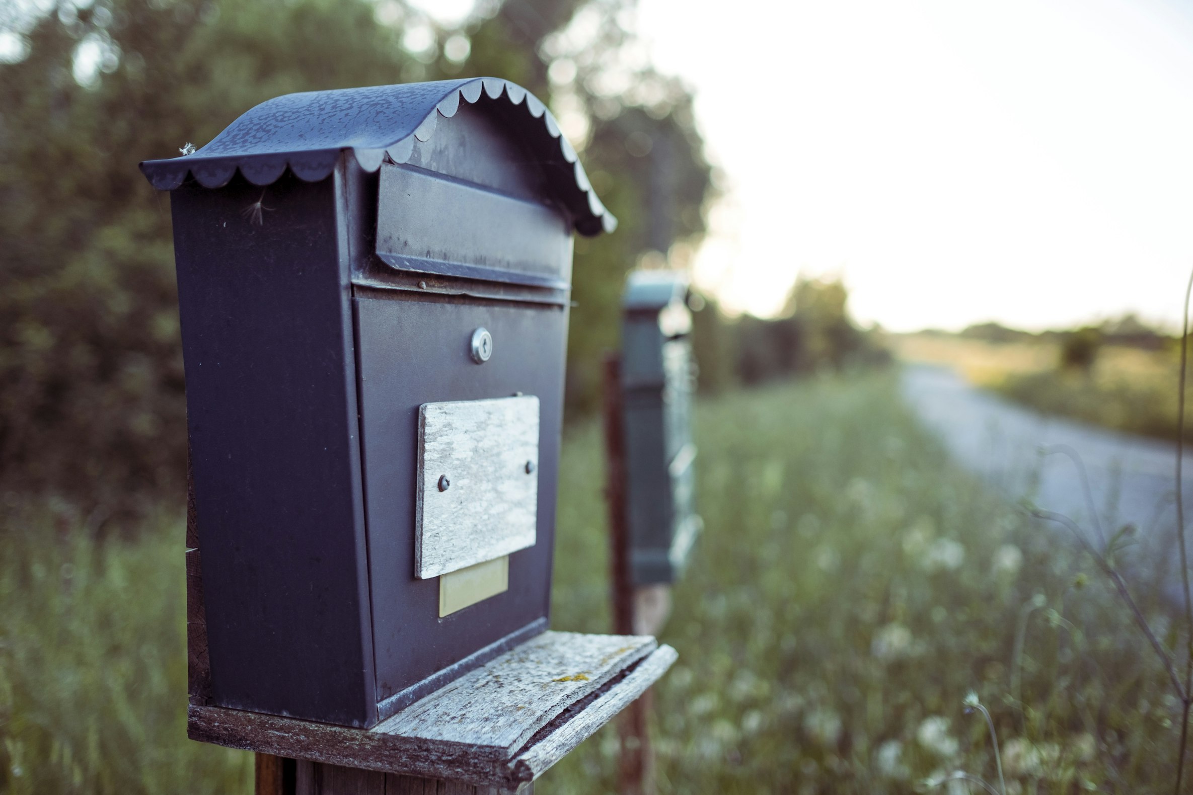 Unsplash image from Davide Baraldi showing a mailbox next to a road.