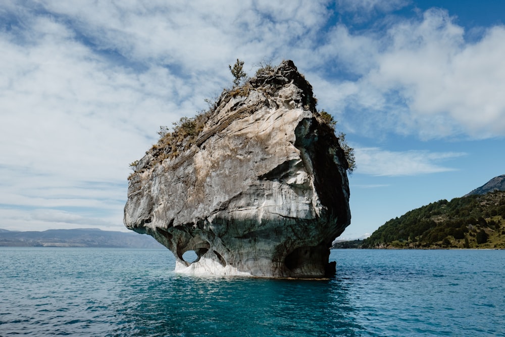 gray rock formation between body of water