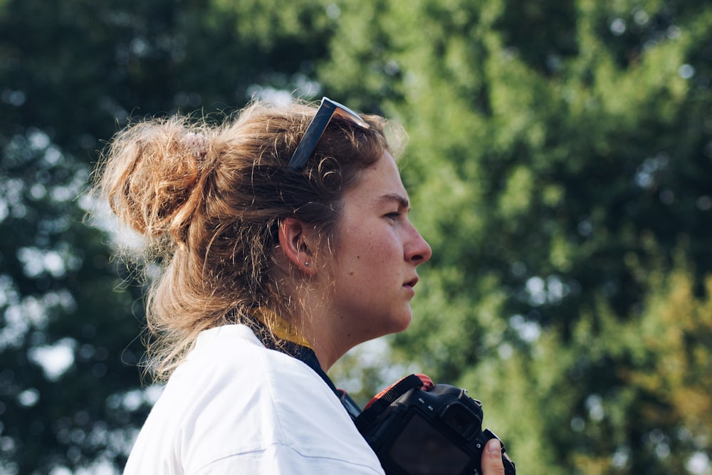 woman holding DSLR camera