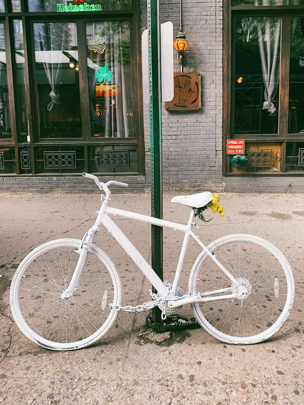 white bicycle on post