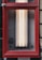 A rectangular red frame encloses a set of vertical fluorescent lights mounted against a wall. There is a small device installed on the left side within the frame. The lower section of the image includes partial text on a sign about an automatic sprinkler shut-off valve.