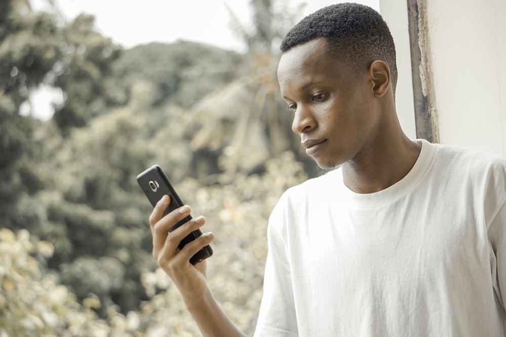 man using black smartphone