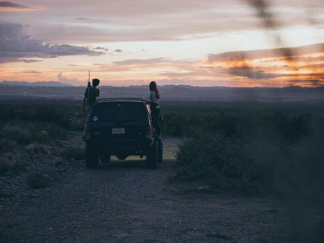 man and woman standing near vehicle