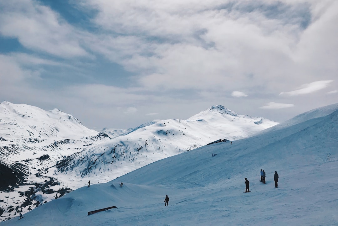 several people standing on hill