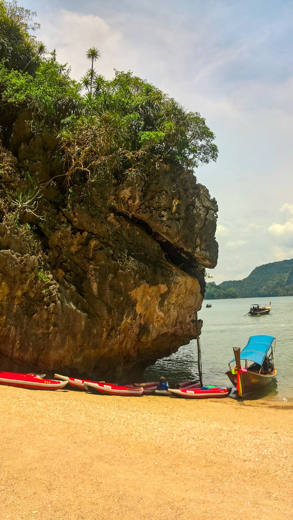 brown wooden boat near rock formation during daytime