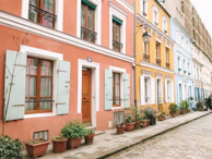 A street scene in Dublin with colorful Georgian doors and blooming window boxes.